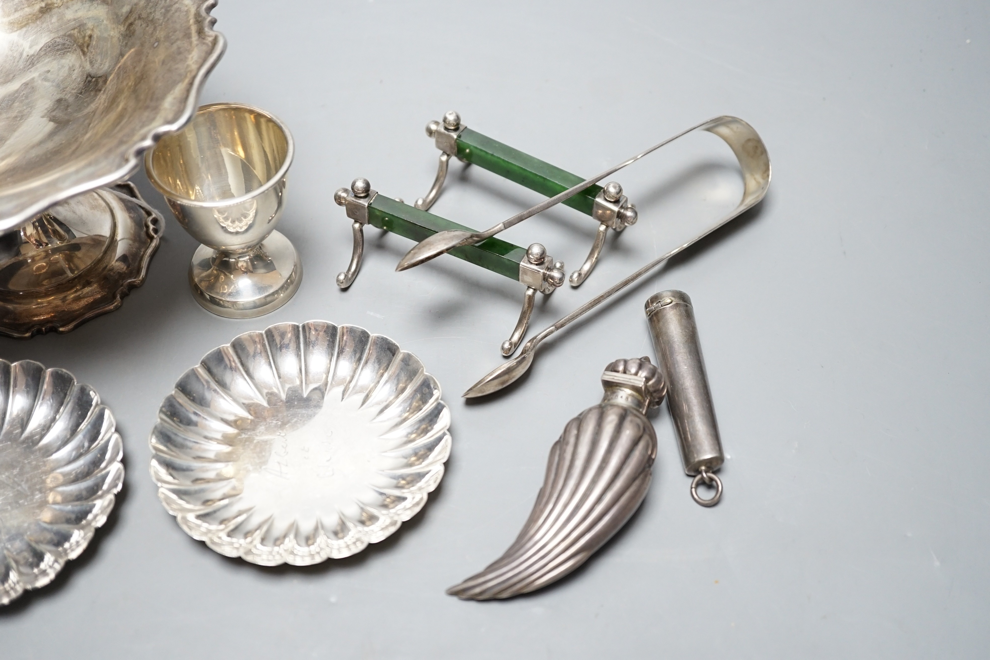 A George V silver tazze, diameter 14.7cm, two small sterling nut dishes, a late Victorian fluted silver scent bottle, of curved form, Horton & Allday, Birmingham, 1889, a pair of silver and nephrite mounted knife rests,